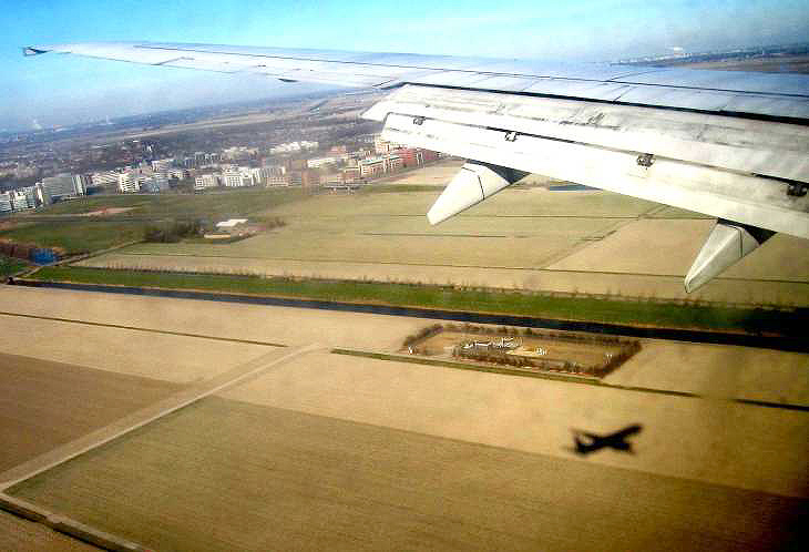 View from aeroplane with plane's shadow, over Holland