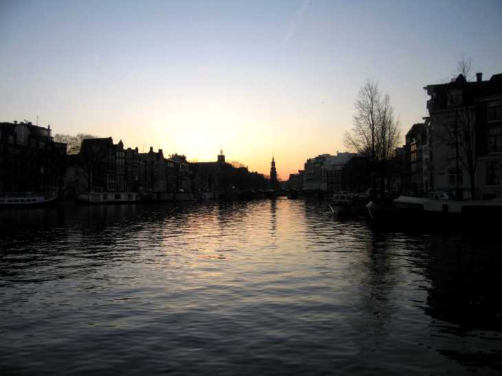 Evening in Amsterdam, Canal at sunset with spire