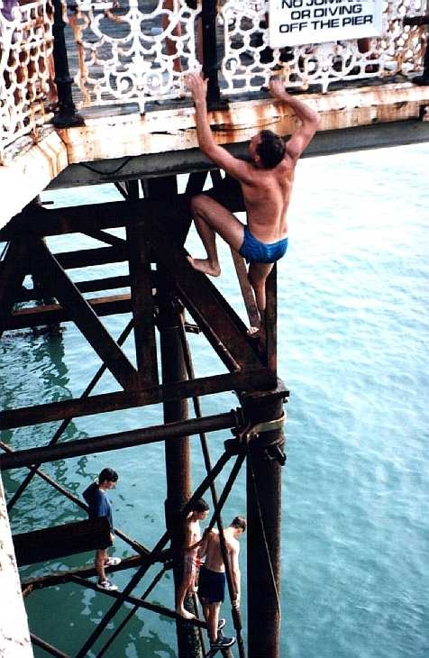 Climbing up the pier, Brighton, Sussex