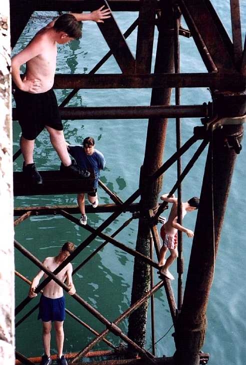 Boys under the pier, Brighton, Sussex