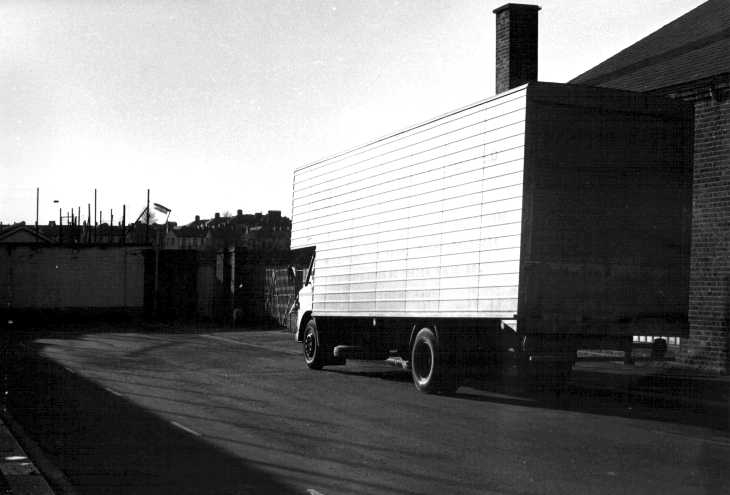 Black and white photograph. Planes of grey in London backstreet