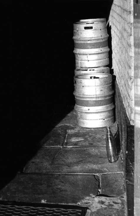 Black and white photograph. Sunlight in alley