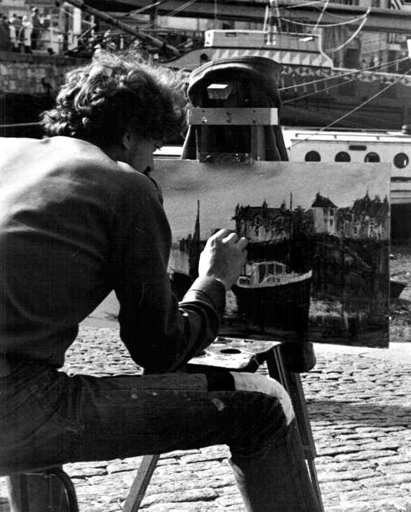 Black and white photo of artist on quayside