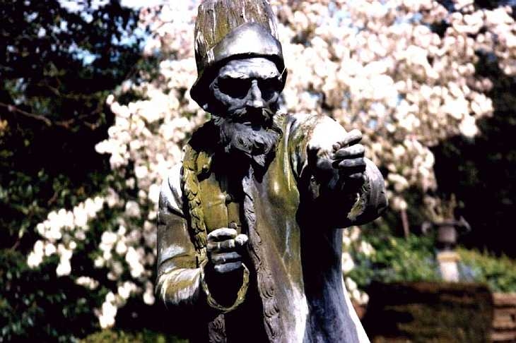 Statue of Shylock, and white blossom, Benington Gardens, Hertfordshire