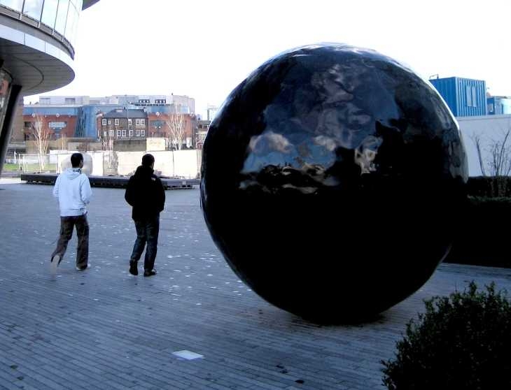 Black ball sculpture outside GLA headquarters, London