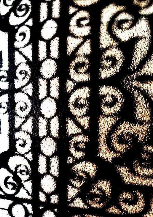 Shadow of wrought iron gate