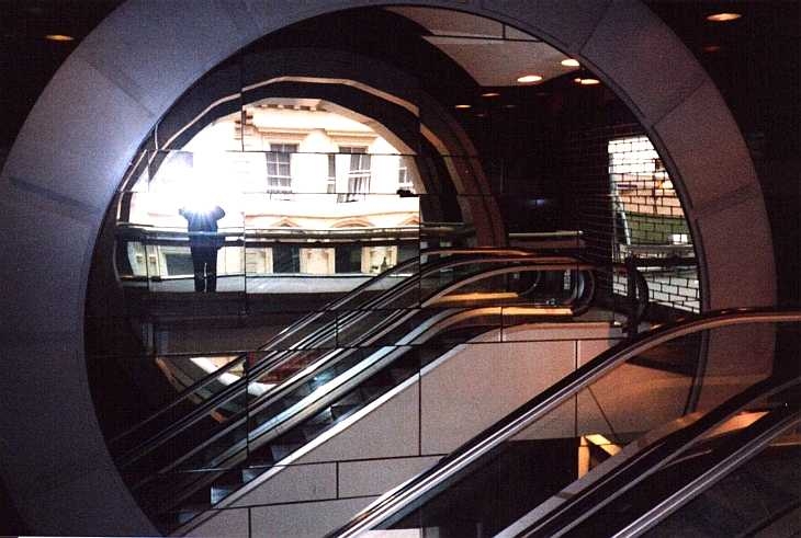 Escalator, mirror, photographer and flash