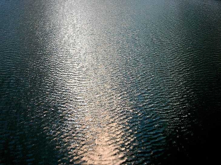 Reflections on water, canal at Islington, London